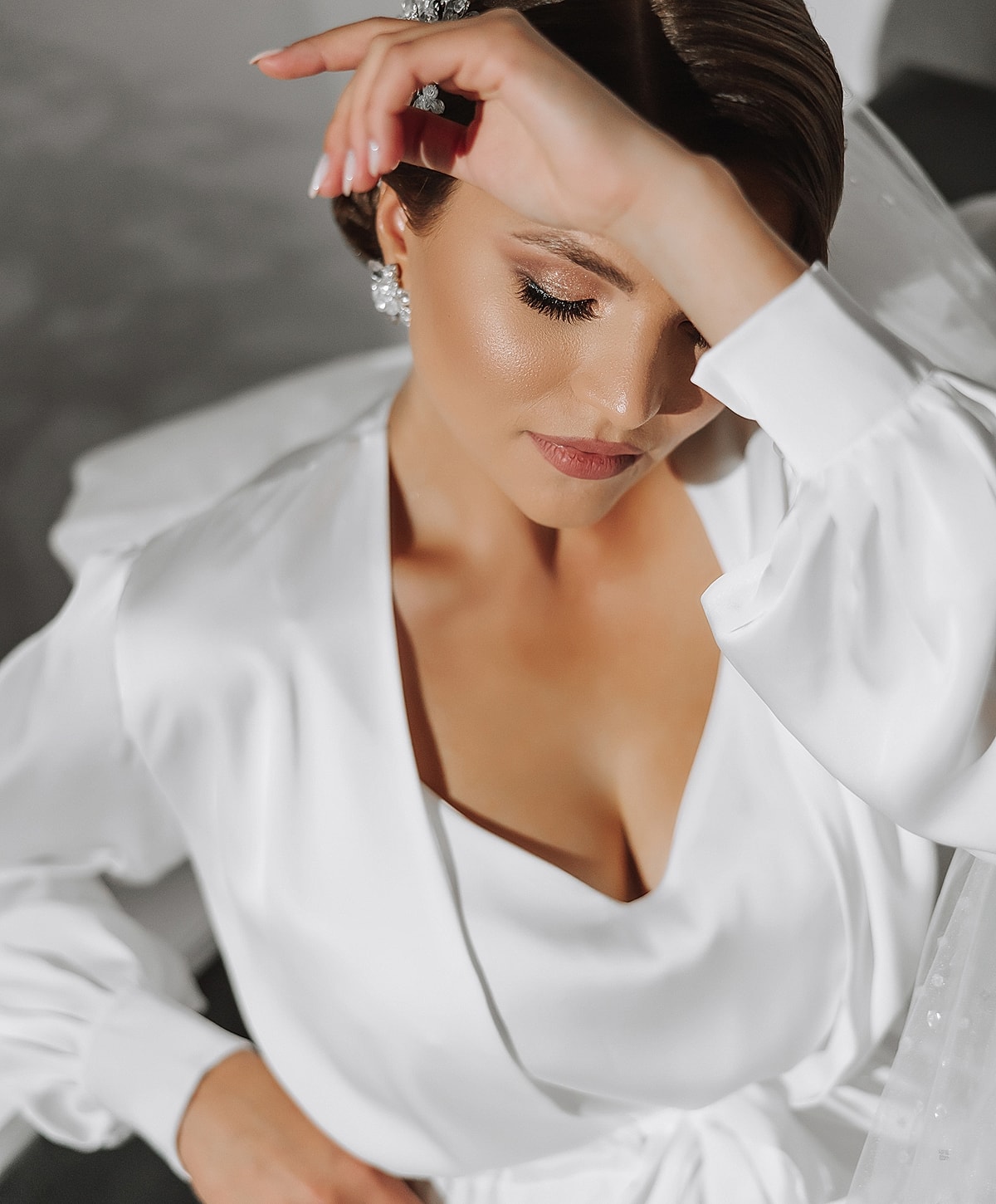 Bride in white dress with elegant hairstyle.